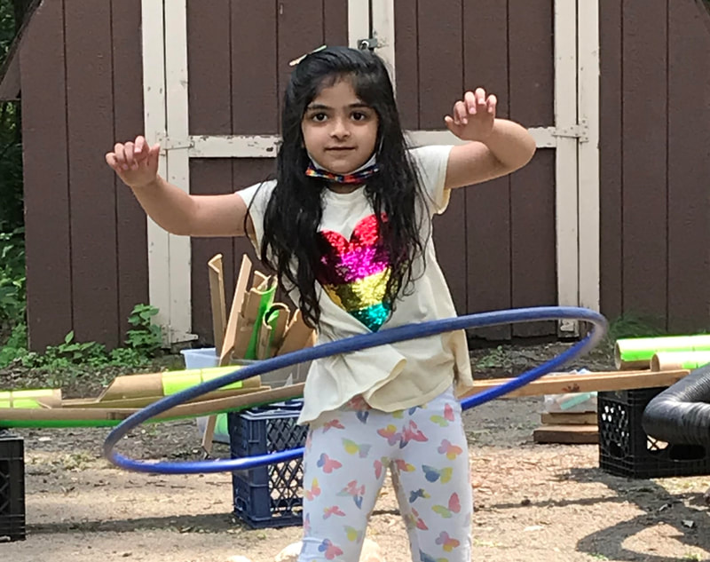 A girl hula hooping outside at Hobson School
